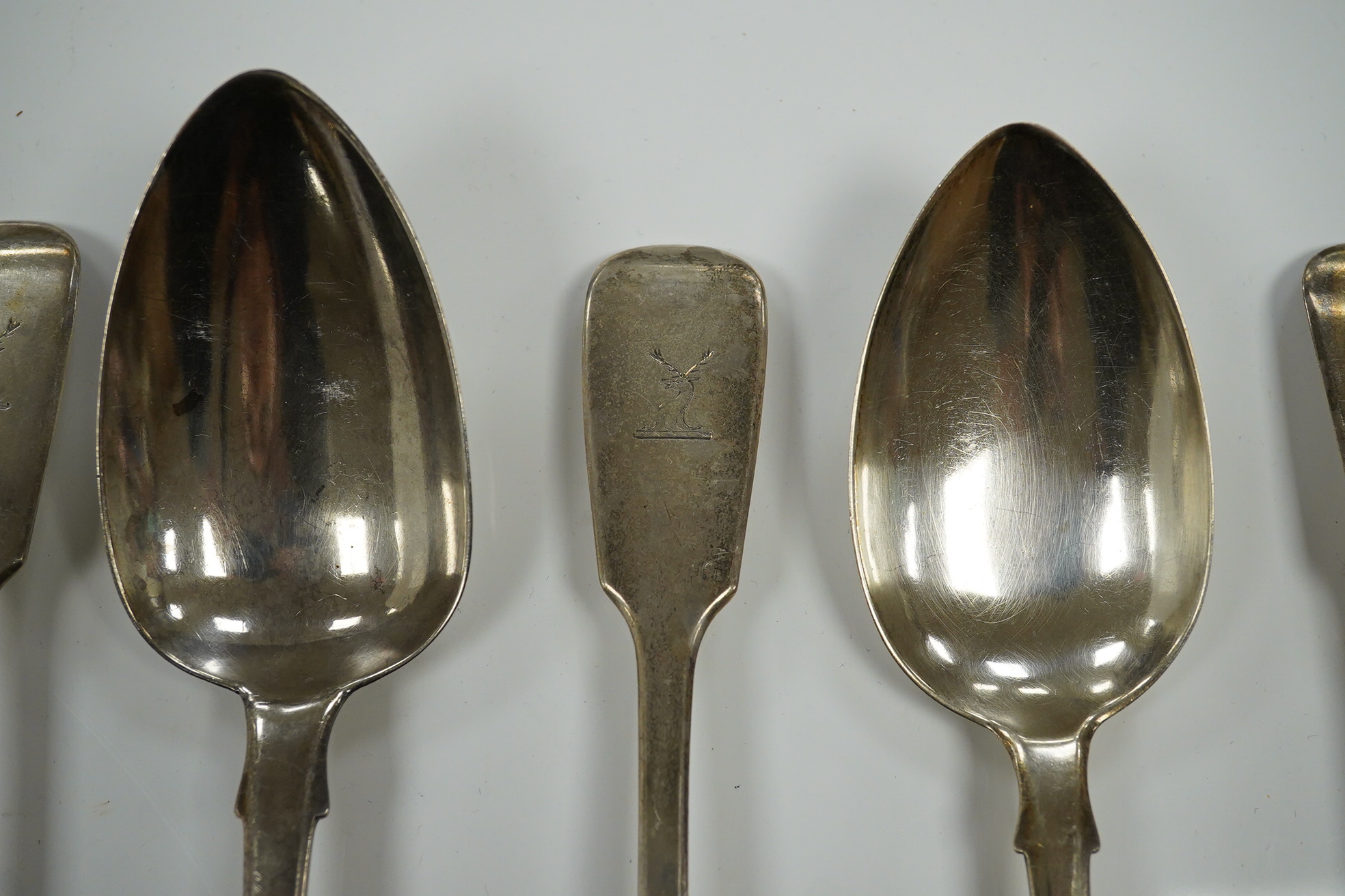 Two William IV and eight Victorian silver fiddle pattern table spoons, various dates and makers, 22.9oz. Condition - poor to fair